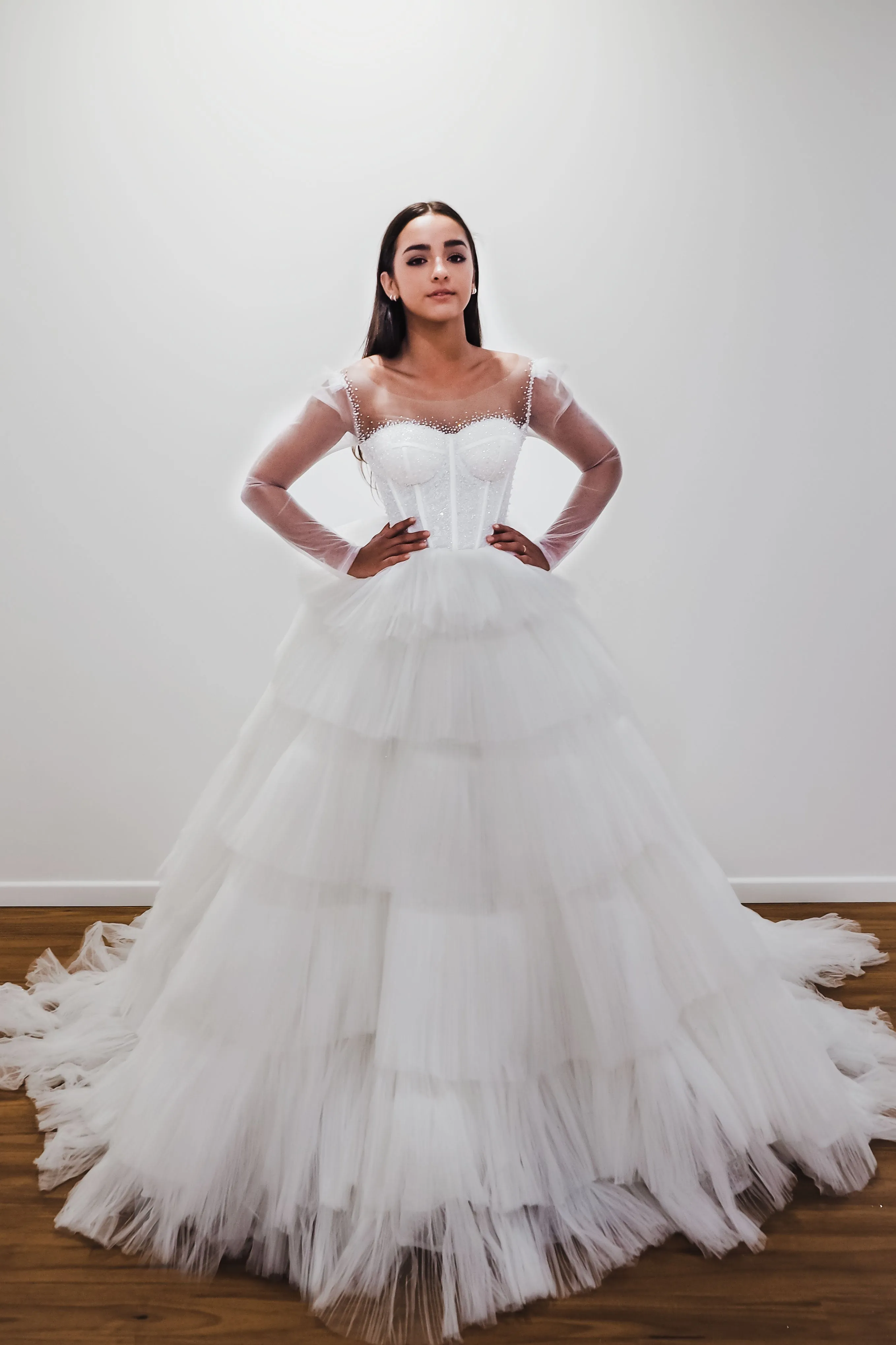 White wedding dress with a bushier top and a bushier puffy layered skirt for hire