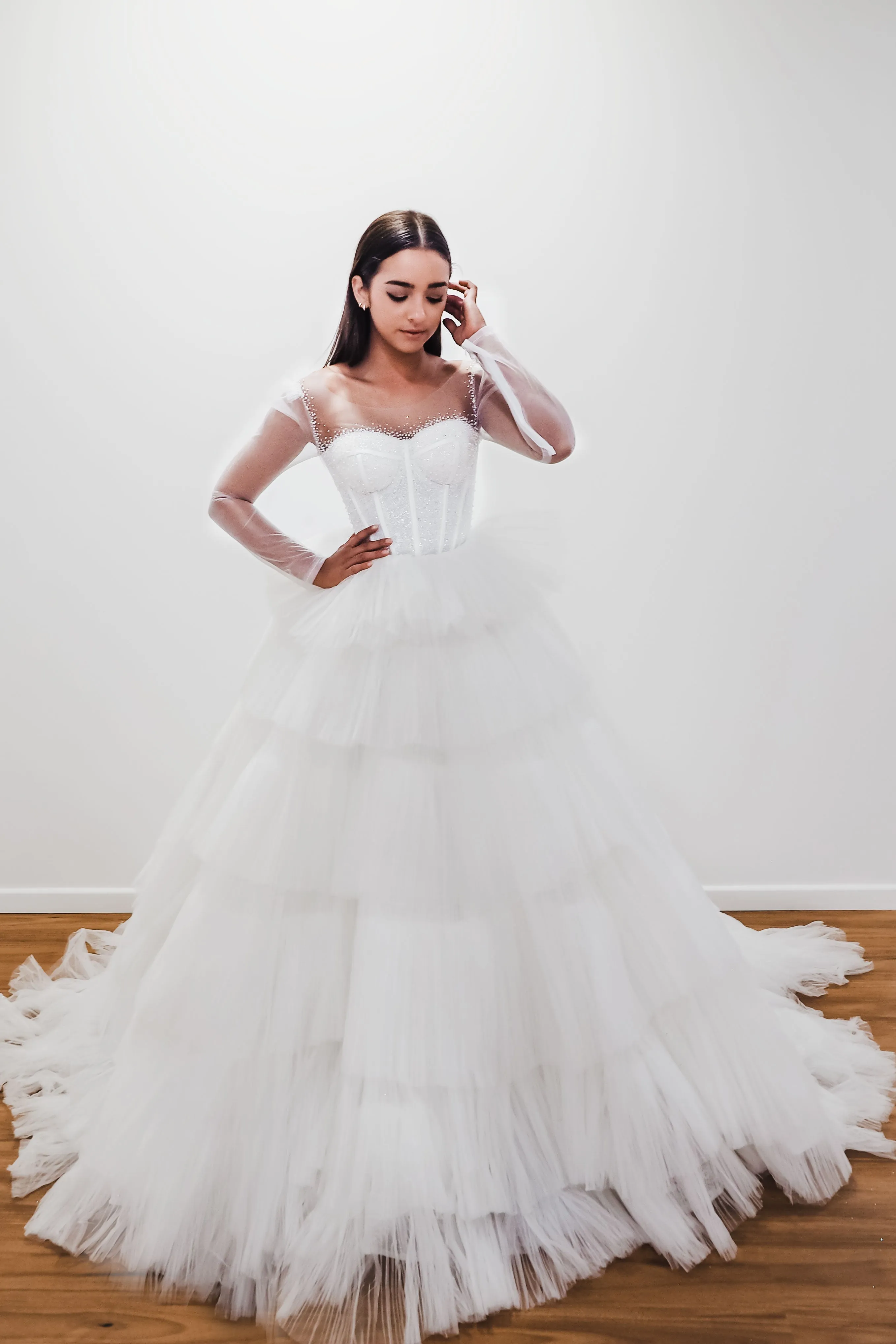 White wedding dress with a bushier top and a bushier puffy layered skirt for hire
