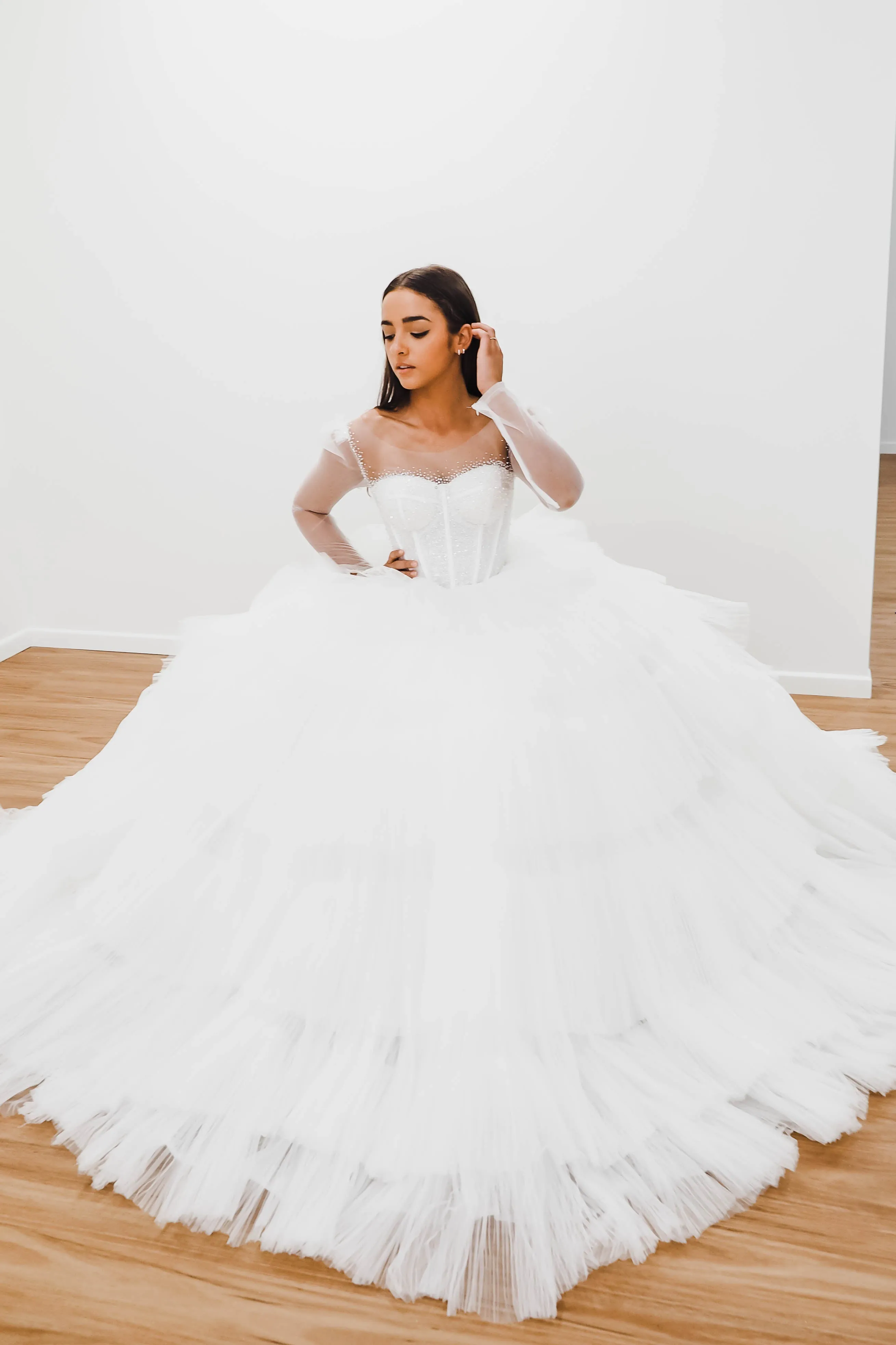 White wedding dress with a bushier top and a bushier puffy layered skirt for hire