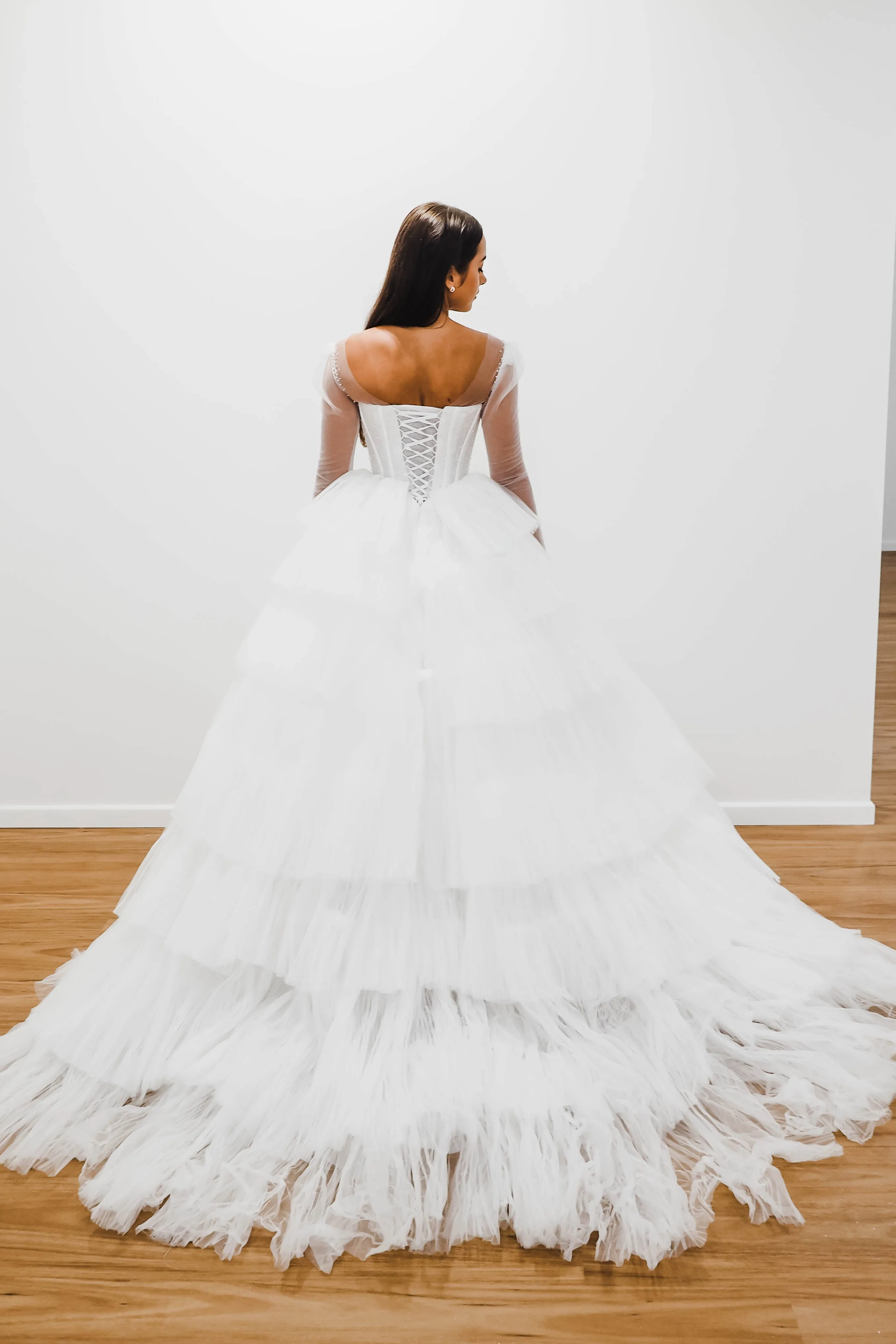 White wedding dress with a bushier top and a bushier puffy layered skirt for hire