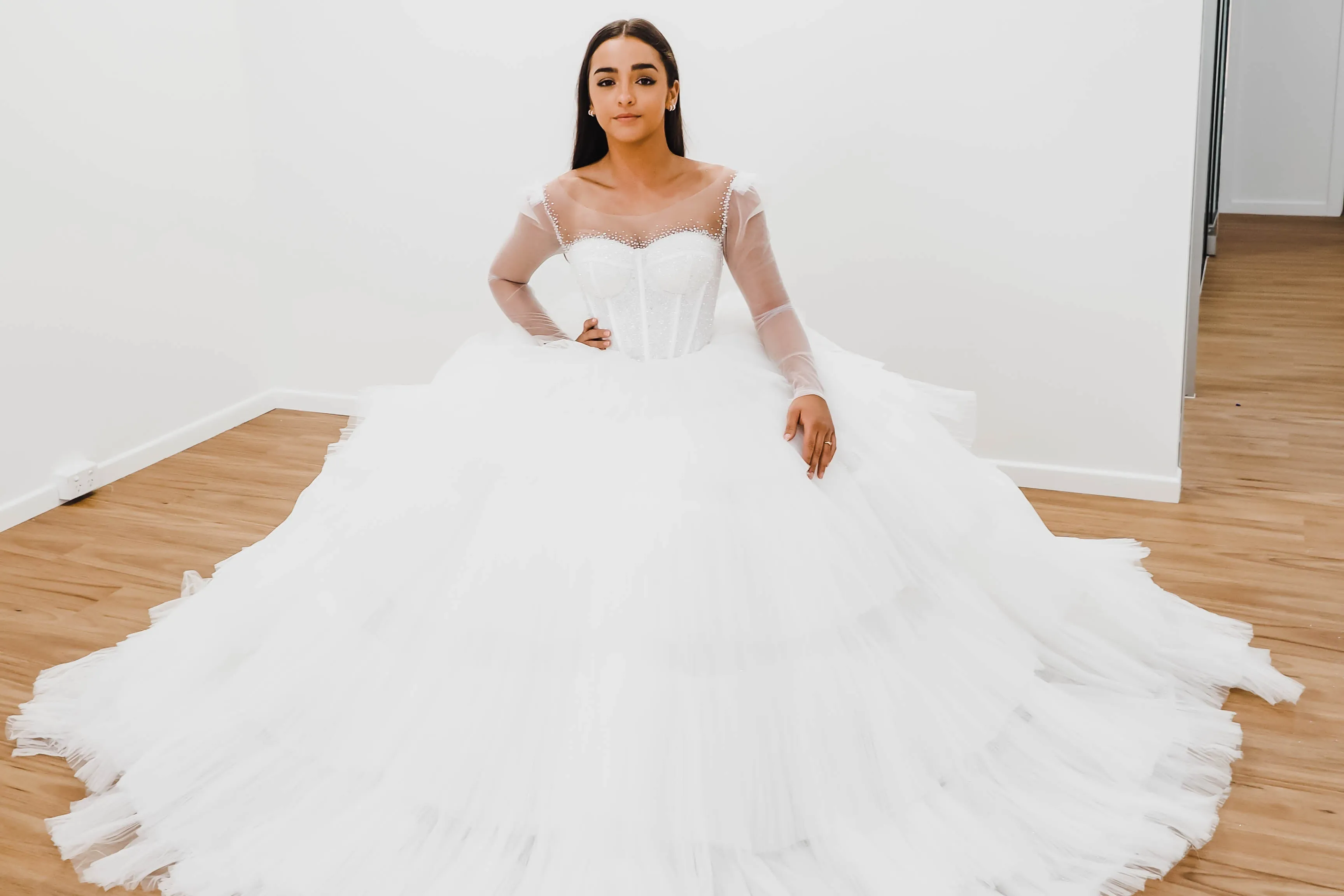 White wedding dress with a bushier top and a bushier puffy layered skirt for hire