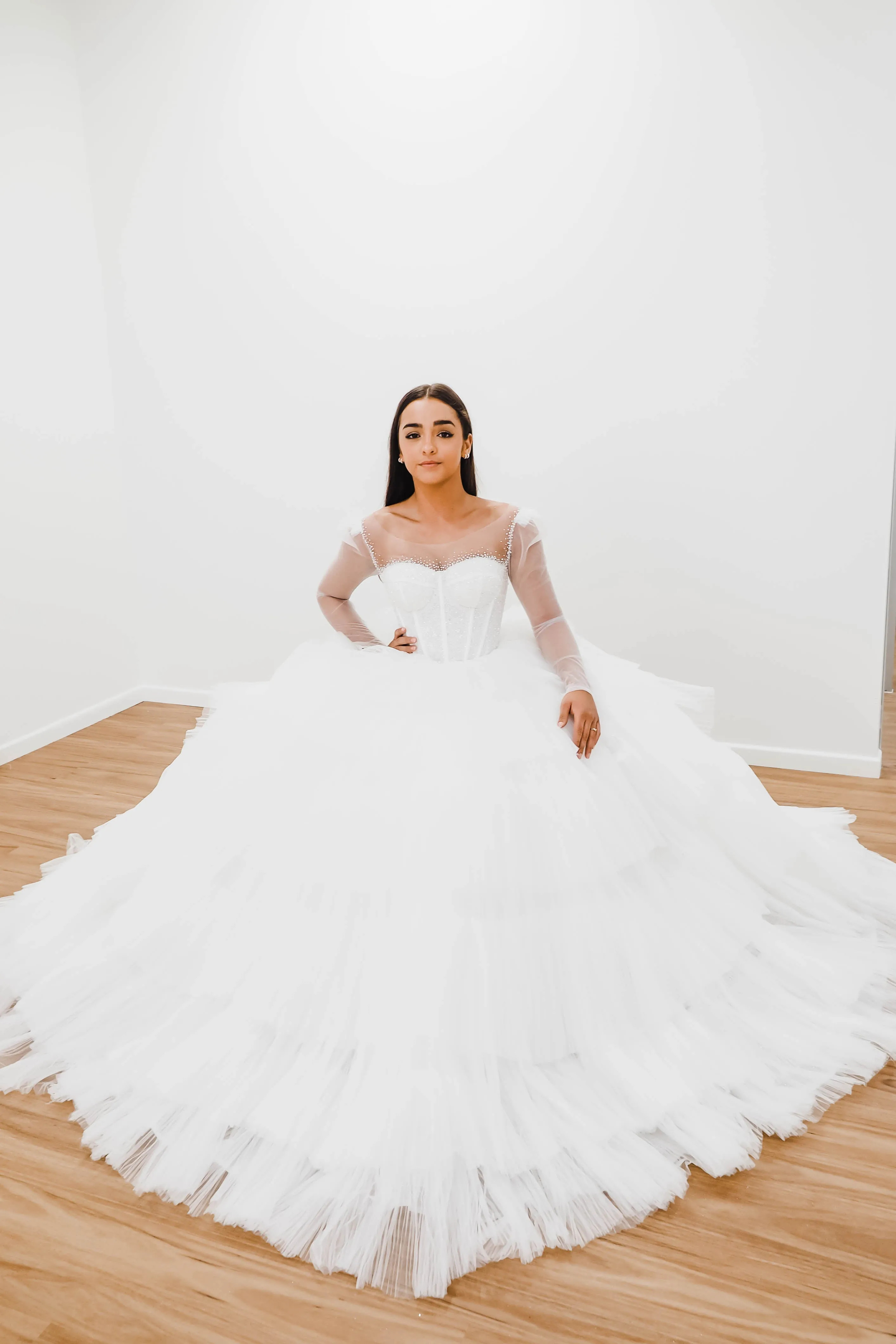 White wedding dress with a bushier top and a bushier puffy layered skirt for hire