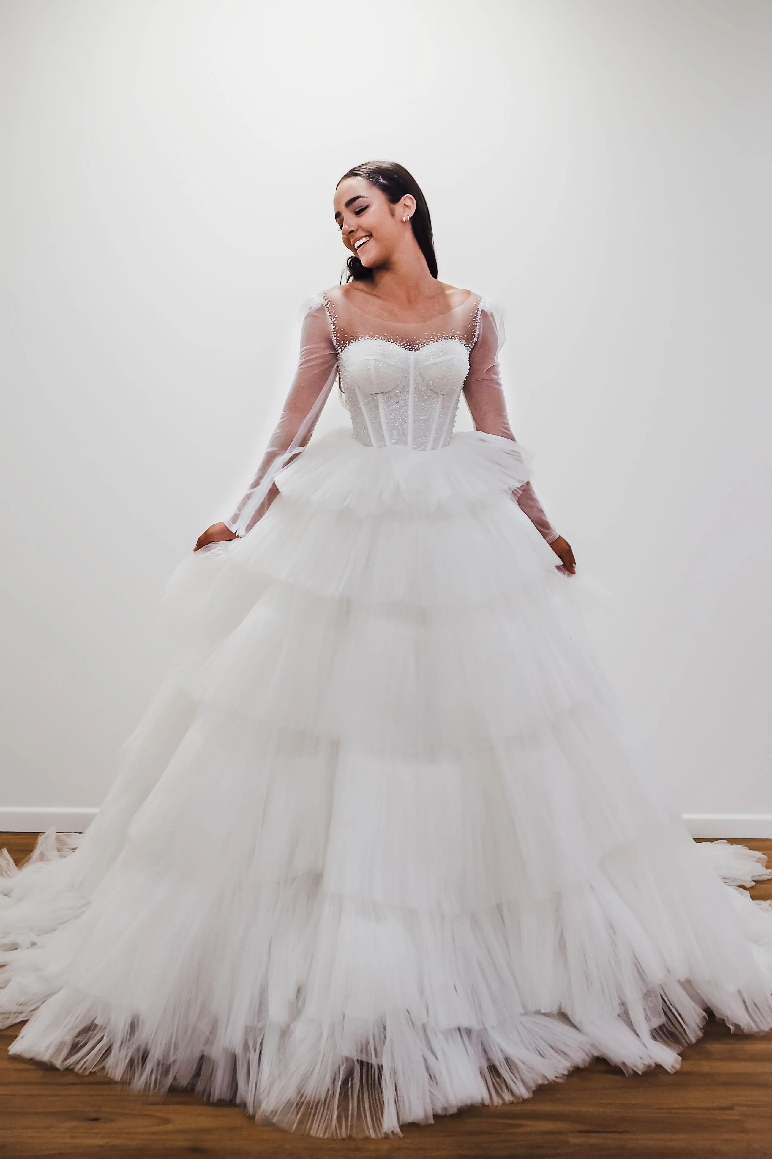 White wedding dress with a bushier top and a bushier puffy layered skirt for hire