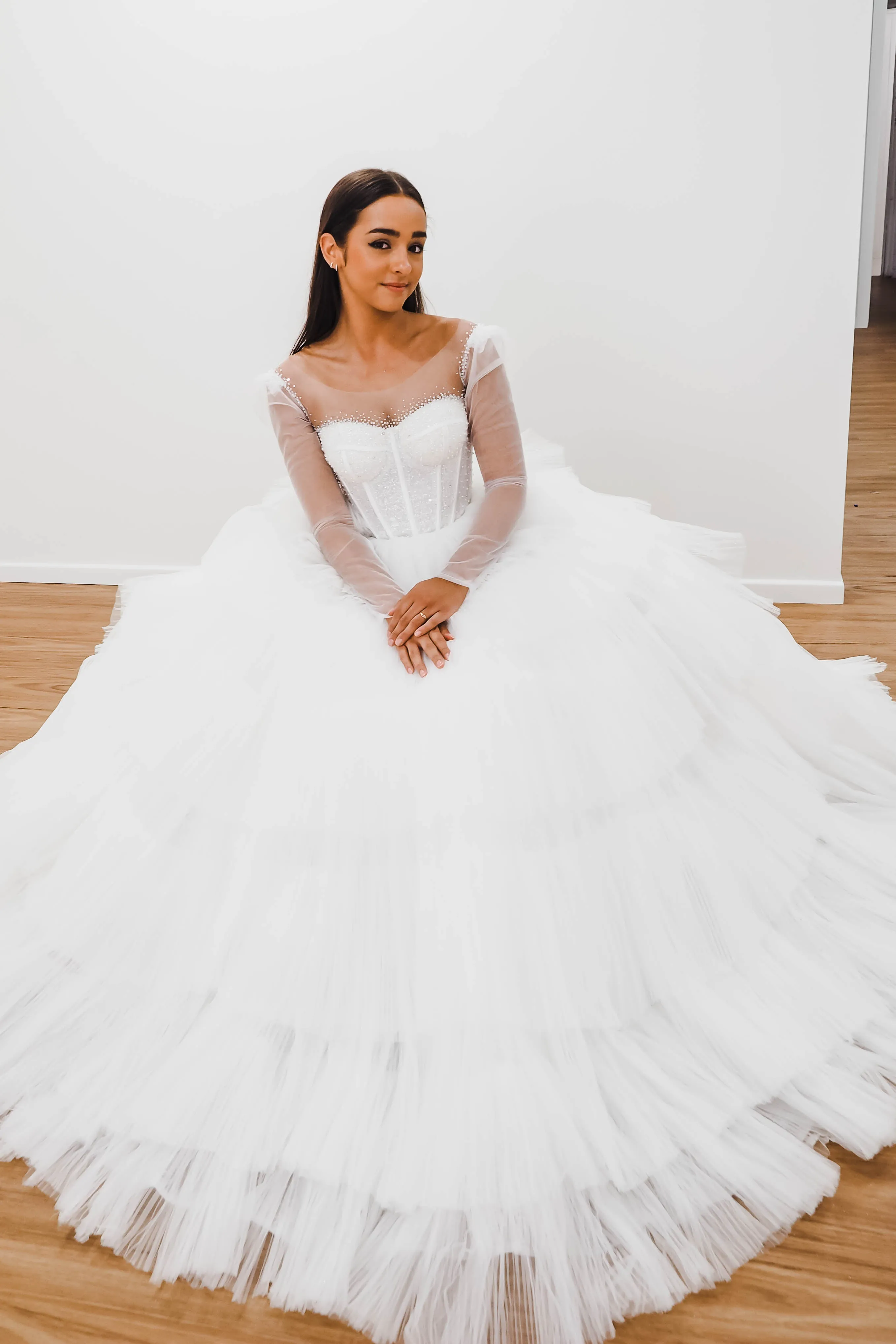 White wedding dress with a bushier top and a bushier puffy layered skirt for hire