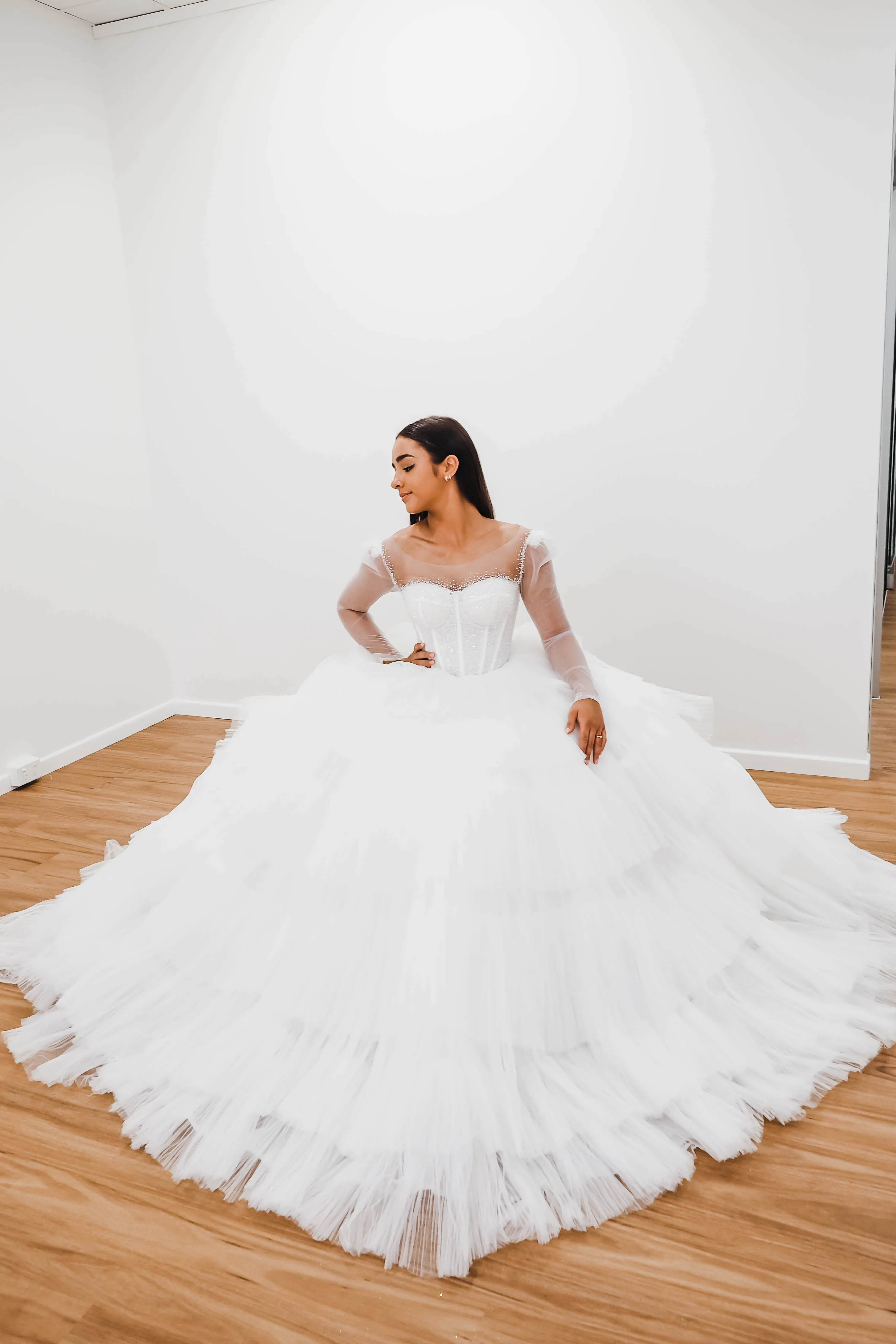 White wedding dress with a bushier top and a bushier puffy layered skirt for hire