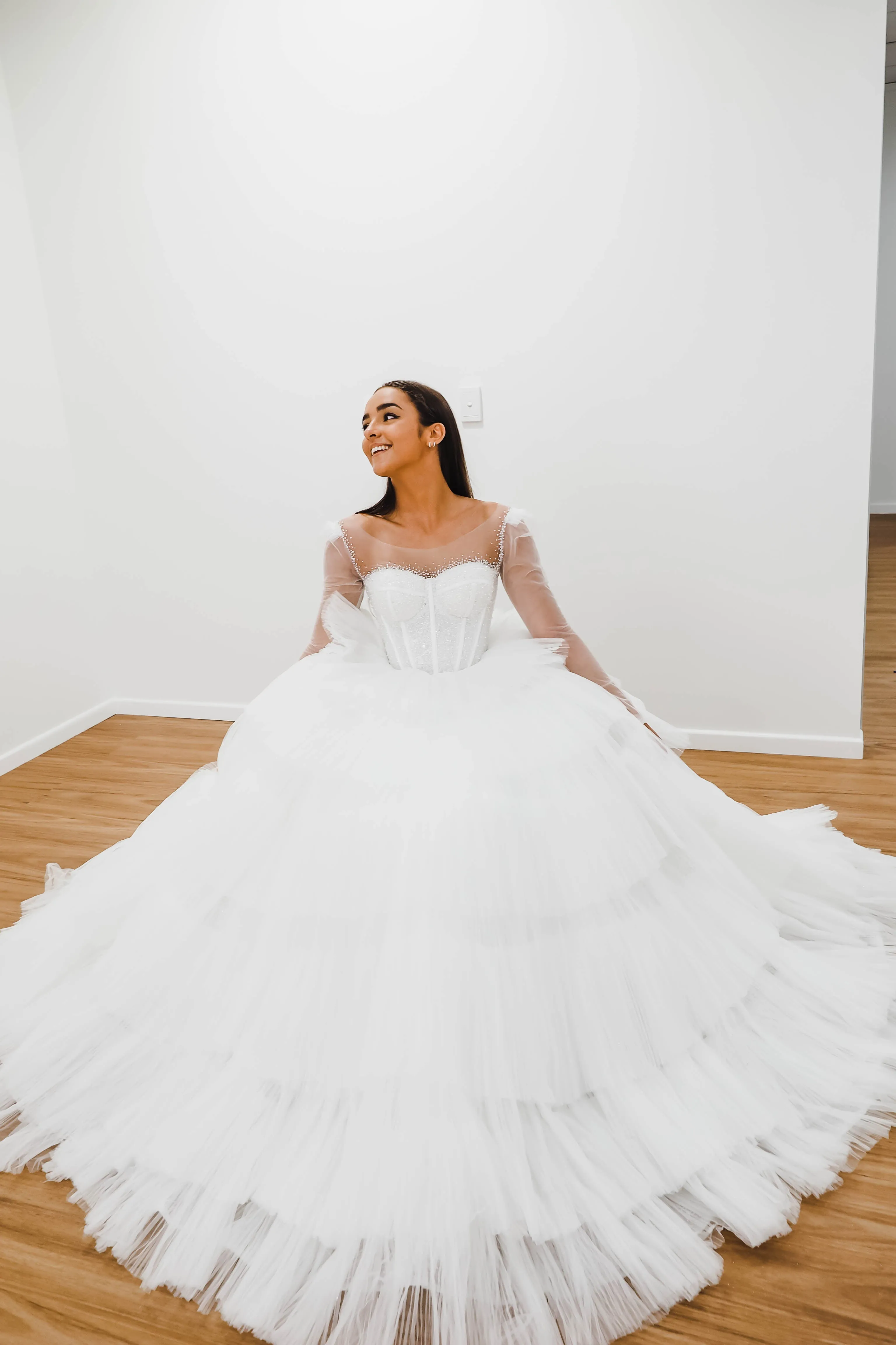 White wedding dress with a bushier top and a bushier puffy layered skirt for hire