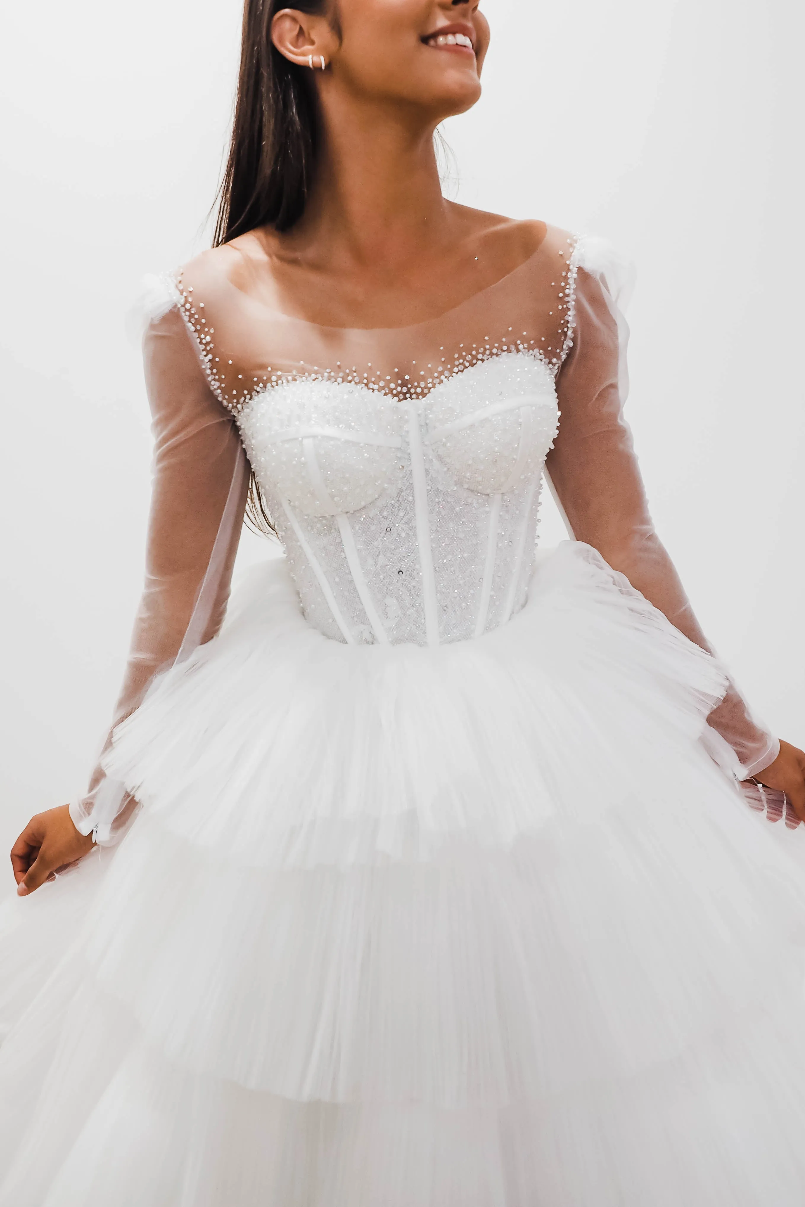 White wedding dress with a bushier top and a bushier puffy layered skirt for hire