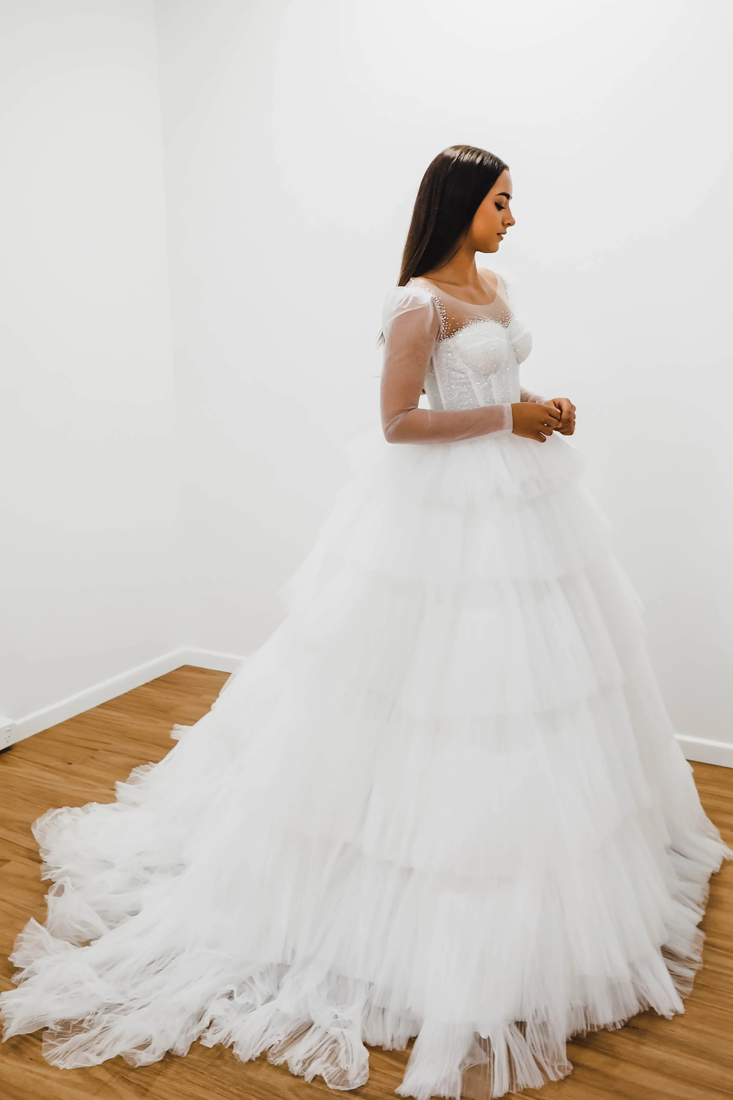 White wedding dress with a bushier top and a bushier puffy layered skirt for hire