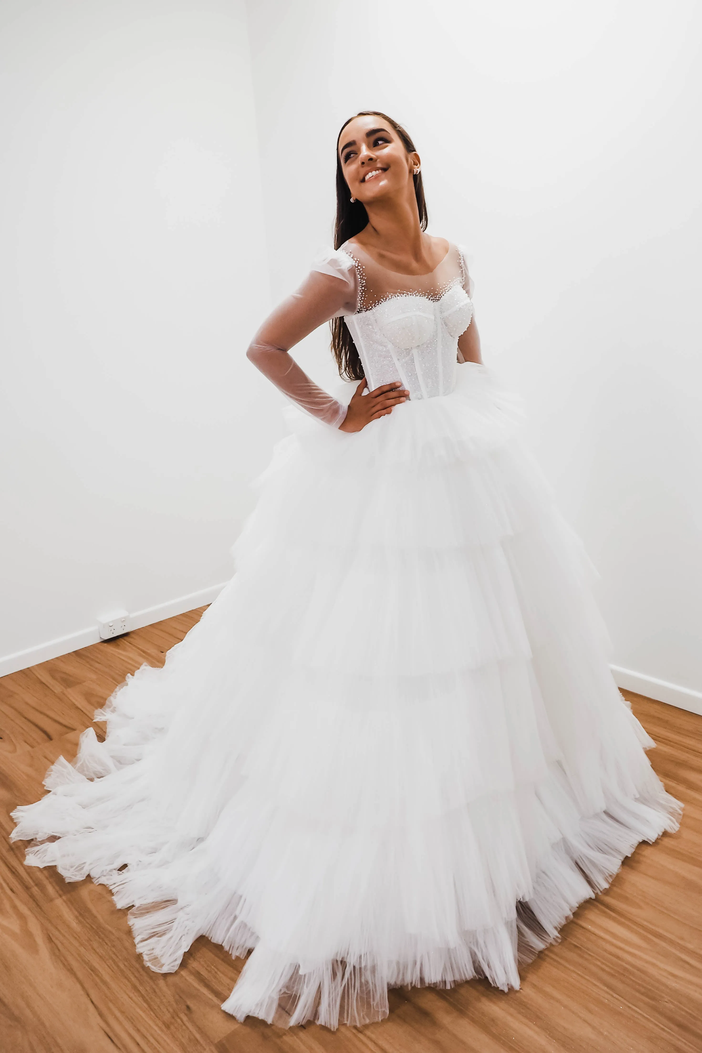 White wedding dress with a bushier top and a bushier puffy layered skirt for hire
