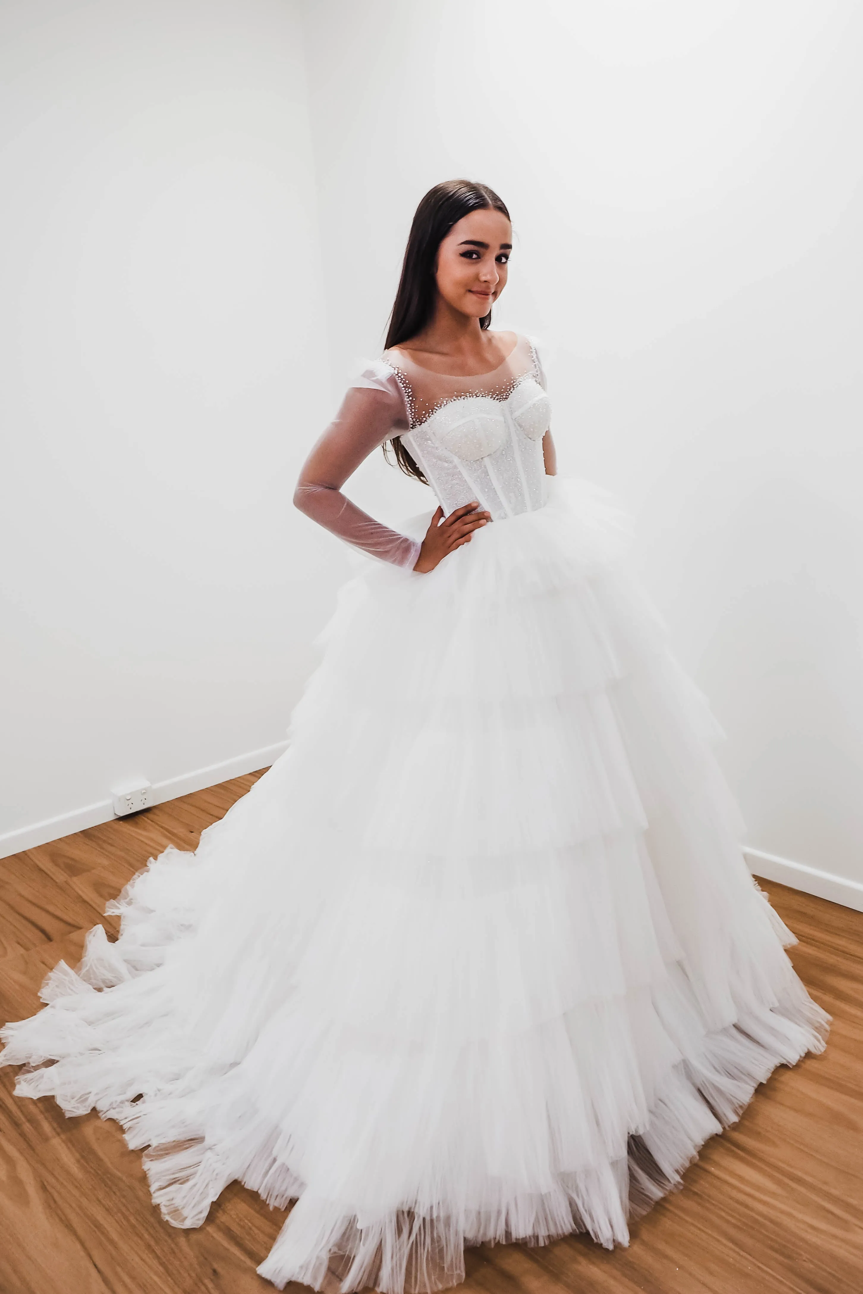 White wedding dress with a bushier top and a bushier puffy layered skirt for hire