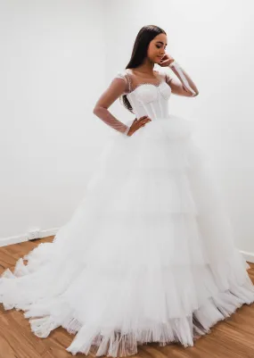 White wedding dress with a bushier top and a bushier puffy layered skirt for hire