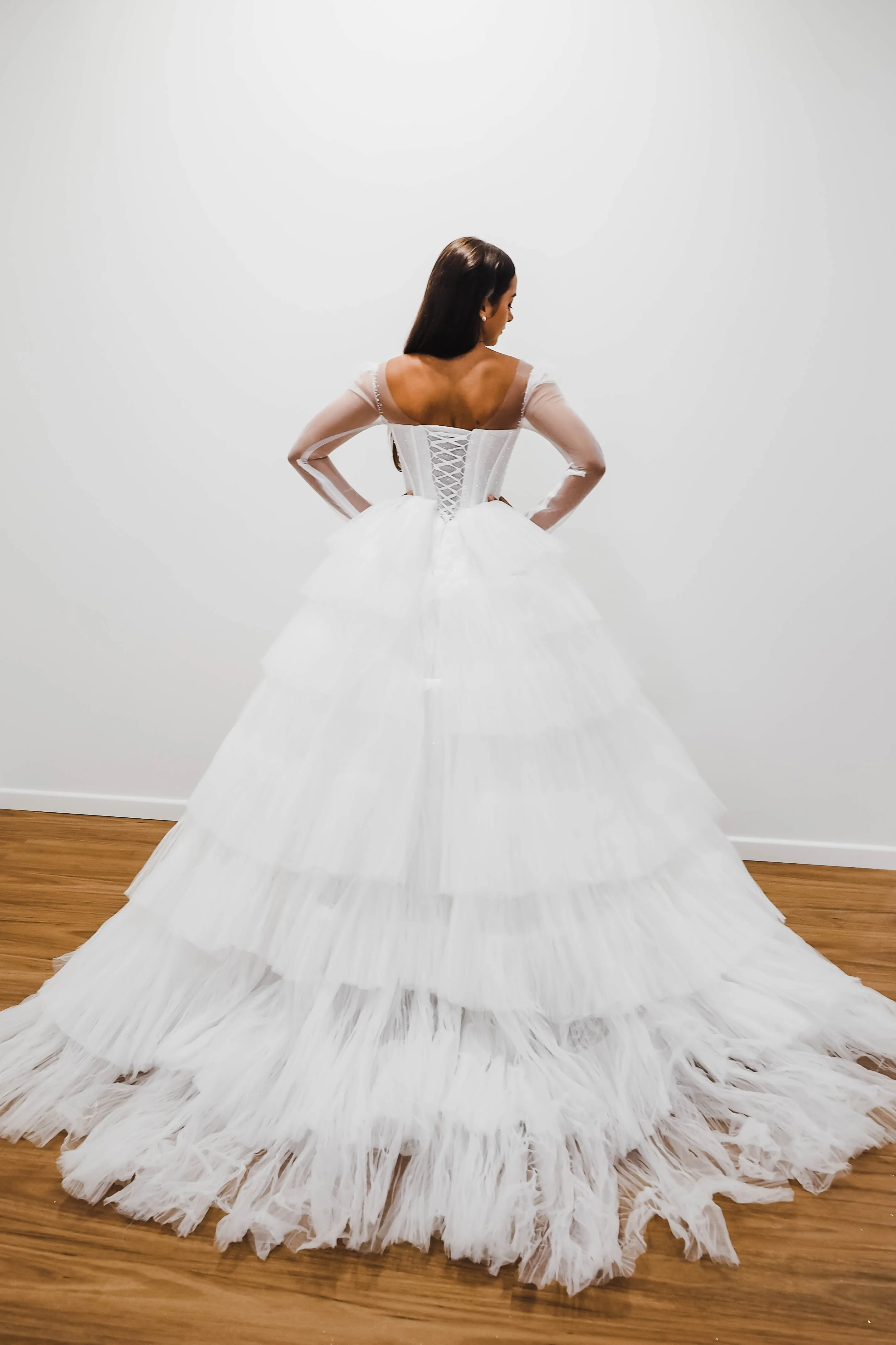 White wedding dress with a bushier top and a bushier puffy layered skirt for hire