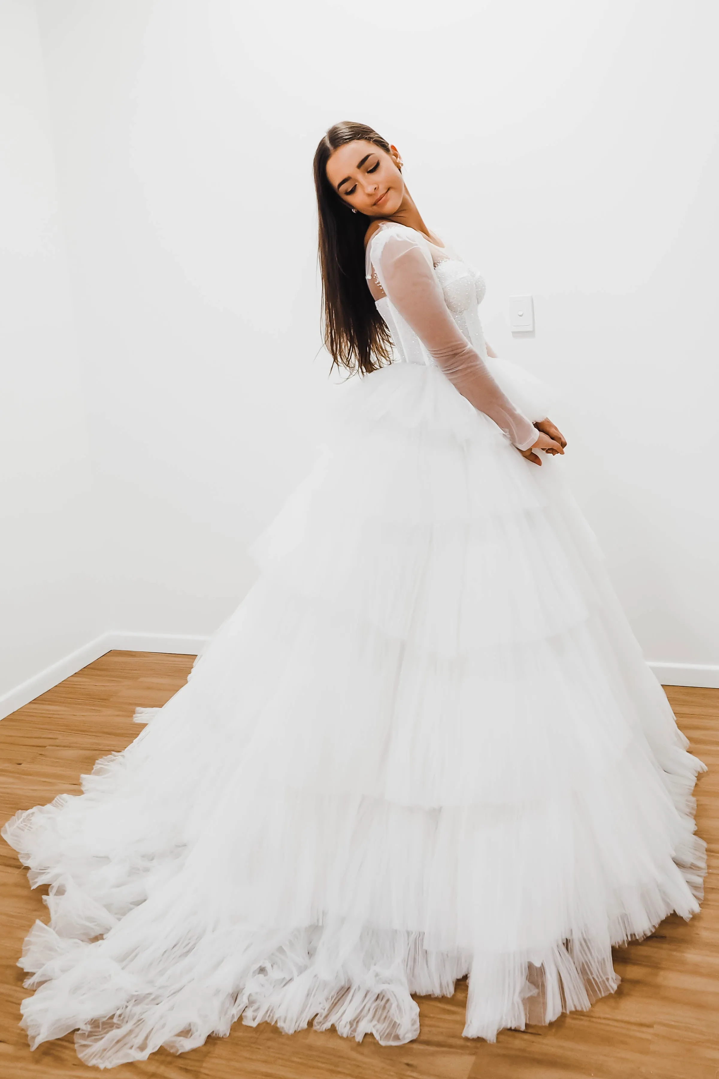 White wedding dress with a bushier top and a bushier puffy layered skirt for hire